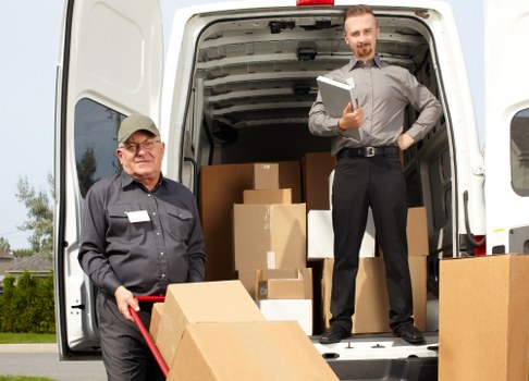 Moving team handling furniture in a central London street